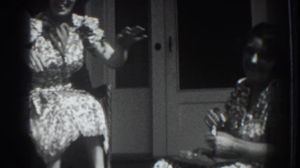 Vacaville, California 1937 home-movie frame of two women seated on a porch, with one gesturing in a candid social moment.