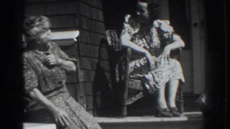Two women seated on a porch appear to converse in 1937 Vacaville home-movie footage.