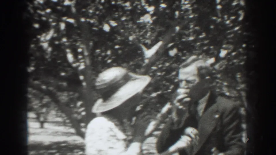 The final frame shows the small group more clearly in the 1937 Vacaville orchard, with a broad hat, suit jacket, and leafy branches around them.