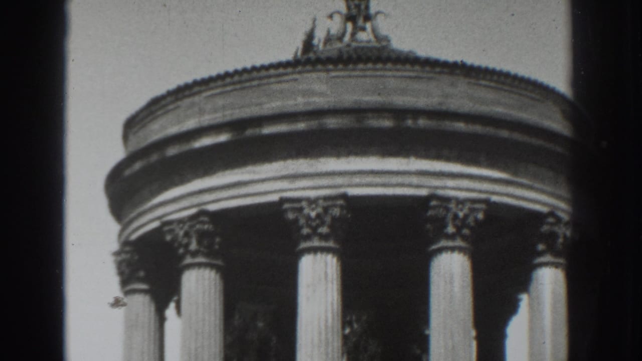 Upper portion of a round classical rotunda with fluted columns and ornate capitals.