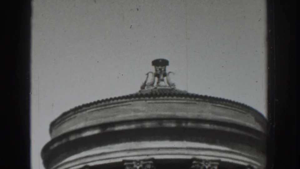 Final 1937 Vacaville still showing the rotunda's curved roofline, finial, and column tops in grainy black-and-white 8mm footage.