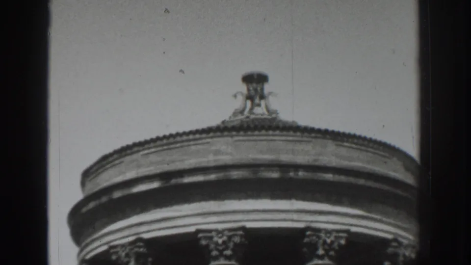 1937 Vacaville home-movie frame showing the upper section of a round classical-style structure with fluted columns and a roof finial.