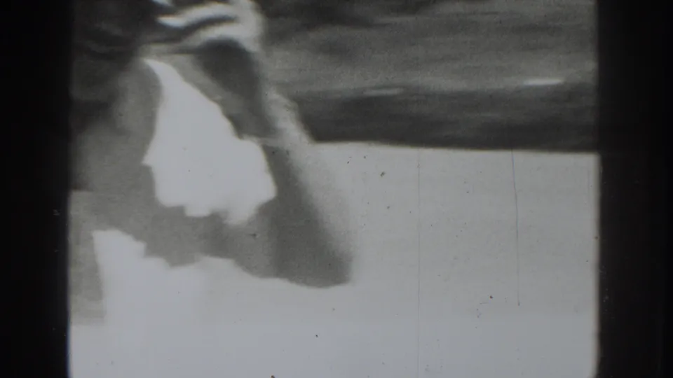 The handheld 8mm frame catches a blurred lower-body view as the person moves across pavement in the Vacaville clip.