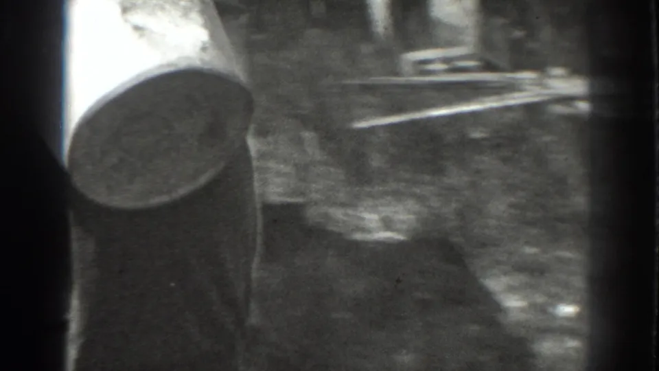 1937 Vacaville 8mm frame with a partial wide-brimmed hat, sunlit ground, and heavy film border at the edge of the shot.