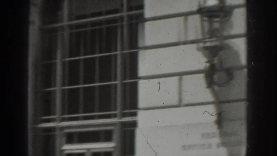 1937 Vacaville exterior detail showing tall metal-gridded windows set into a pale stone government building facade.