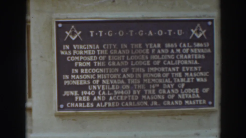 Visitor-shot close-up of the Virginia City Masonic memorial tablet, with the inscription filling most of the 8mm frame.