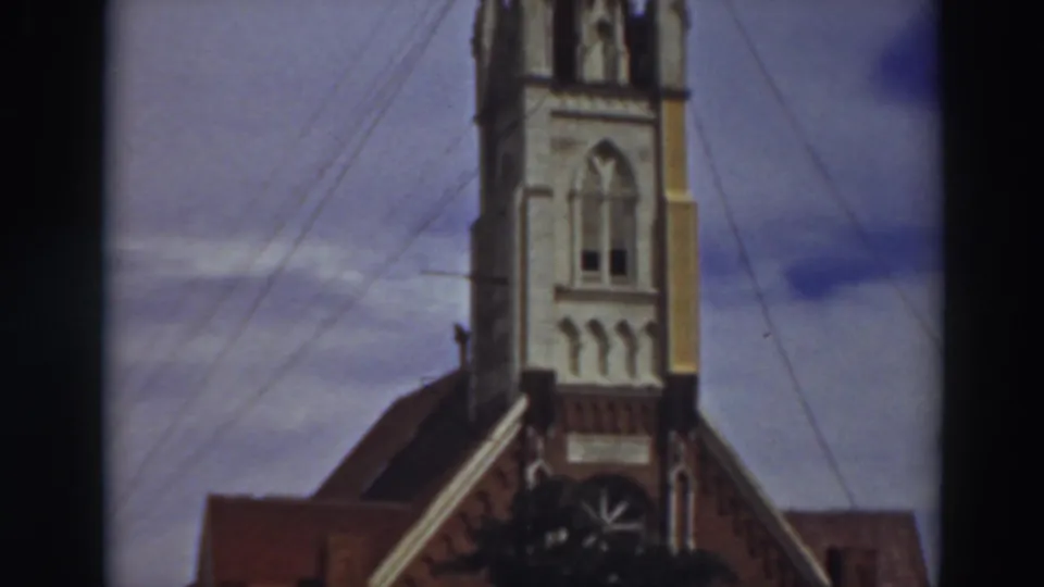 1937 Virginia City, California frame with the church steeple rising above the roofline, crossed by guy-wires and power lines.