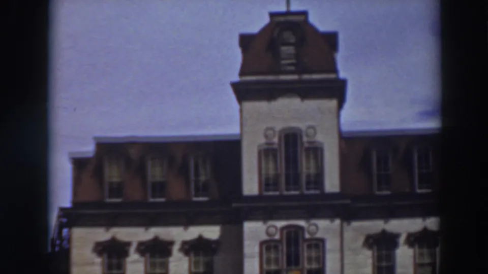 1937 Virginia City home-movie frame emphasizing the cupola and upper facade of the ornate multi-story building.