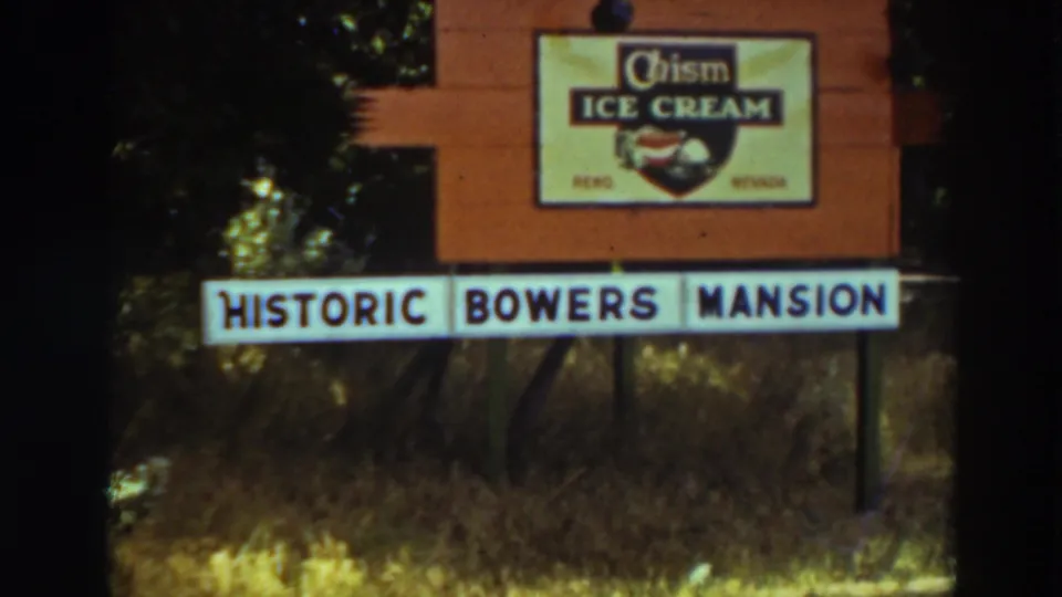 A roadside entrance sign identifies Historic Bowers Mansion, with a visible Chism Ice Cream brand sign above it and trees behind.
