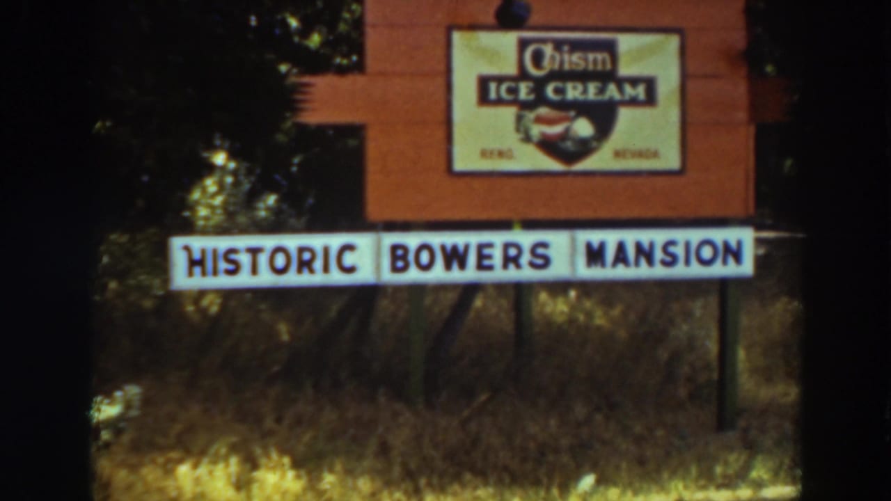 1937 8mm frame showing a Historic Bowers Mansion sign with a Chism Ice Cream board above it in Virginia City, California.