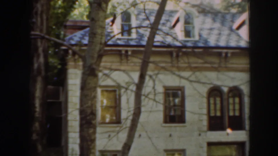 The final frame shows the Virginia City, California house exterior through trees, emphasizing the dormered roof, arched windows, and shaded entry area.