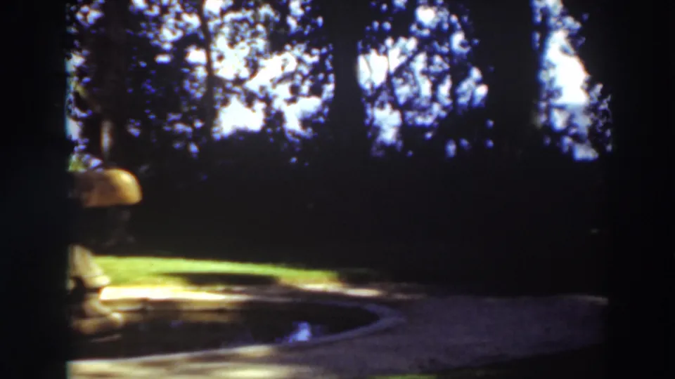 The final 1937 frame shows only part of the fountain at left, with bright grass, dark trees, and the reflection pool dominating the view.