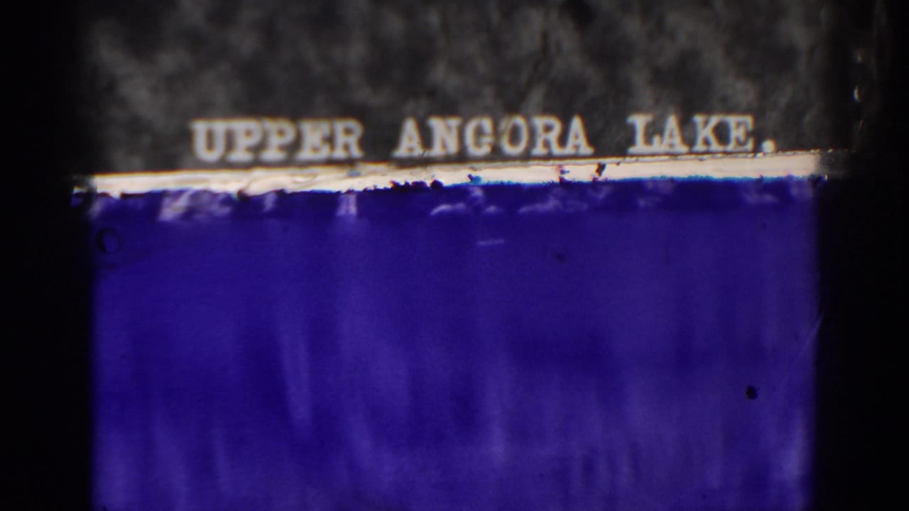 1938 Angora Lakes home-movie frame with an Upper Angora Lake title card and dark 8mm film borders.