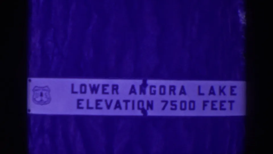 1938 Angora Lakes frame showing the white Lower Angora Lake elevation marker with aged purple-blue 8mm texture.