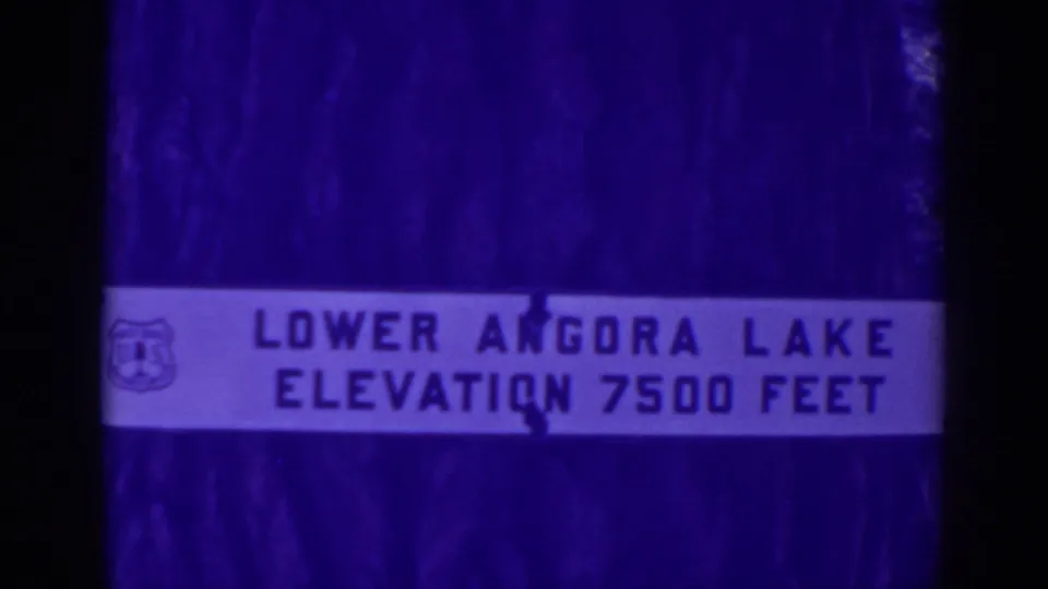 Final frame of the 1938 Angora Lakes sign view, with the elevation text visible through soft aged 8mm color.