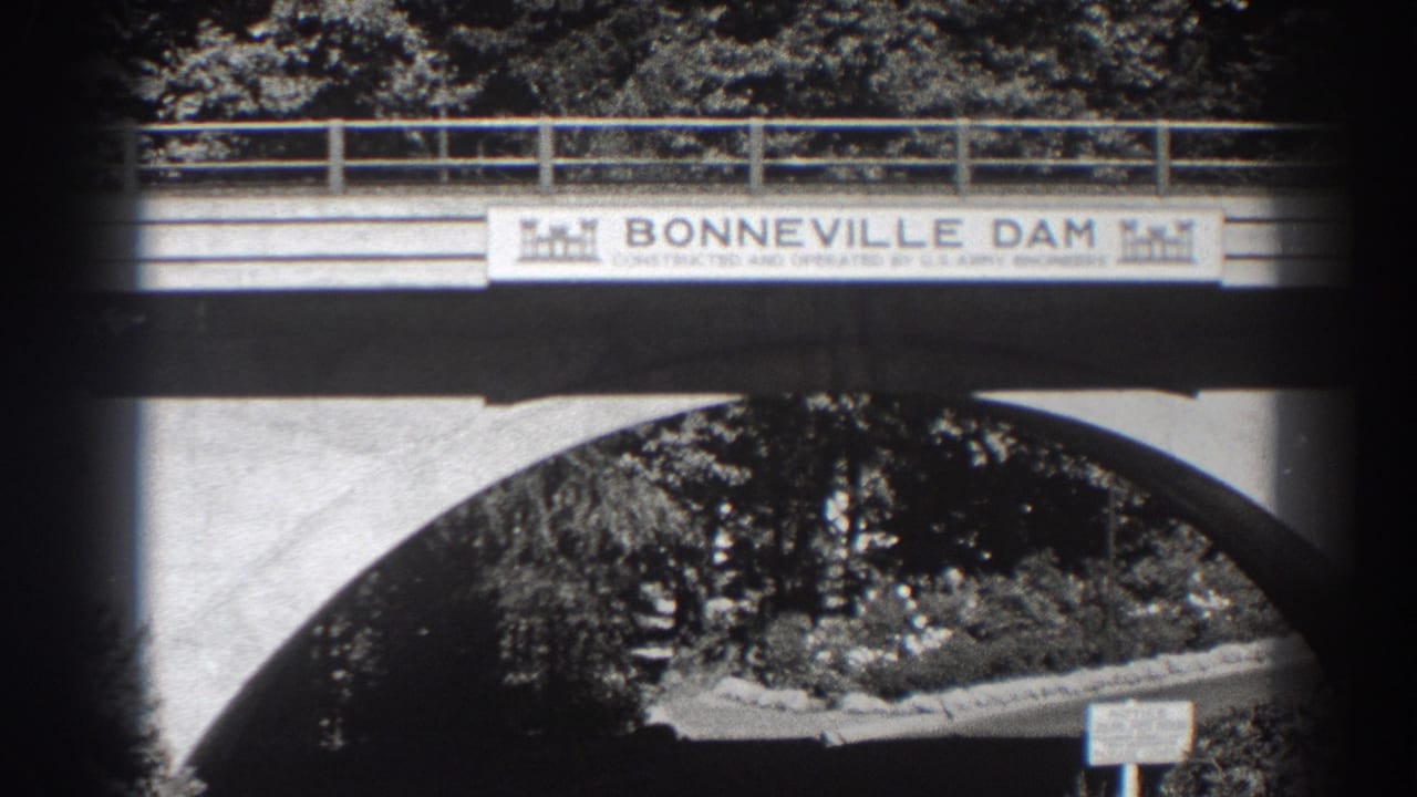 Concrete bridge with Bonneville Dam banner above a large arch.