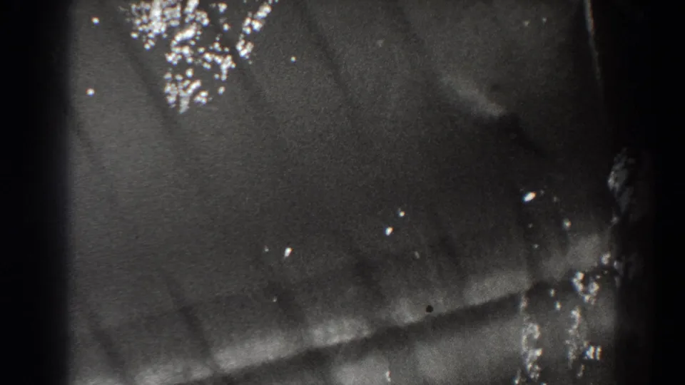 Close 8mm view of moving water and bright reflections within the Bonneville Dam sequence.