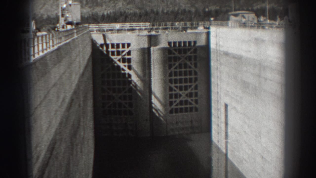 Concrete dam floodgate with gridded panels and dark 8mm frame edges.