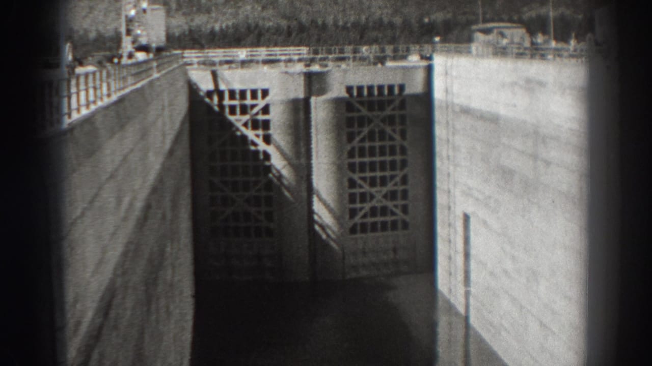 Concrete dam gate and railings framed by dark 8mm borders.