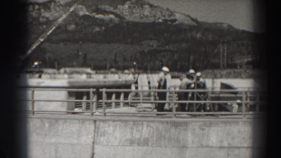 The 1938 Bonneville Dam view shows men gathered near a railing, with concrete works, a small flag, and the Oregon hillside visible behind them.
