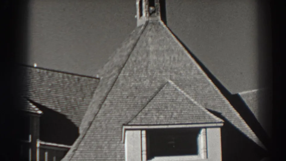 Close 1938 Bonneville Dam architectural view showing roof shingles, dormer-like opening, and part of a small tower.