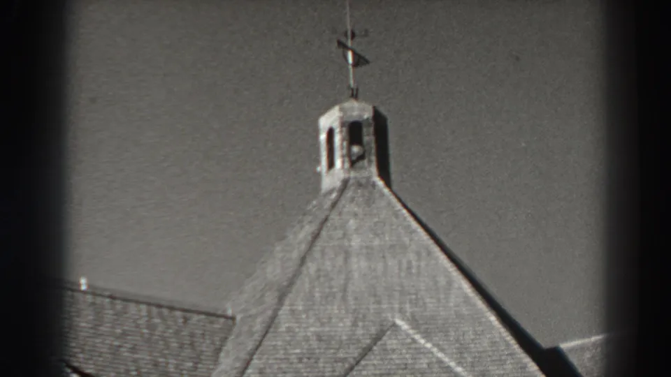 1938 Bonneville Dam roof detail centered on a small bell tower and weather vane above textured shingles.