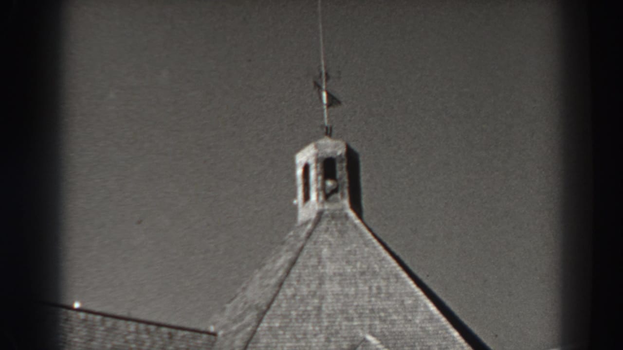 Cupola roof and partial American flag scene under a bright sky.