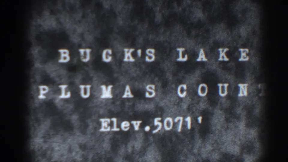 1938 Bucks Lake, California title card with white lettering on a textured grey and black 8mm frame.