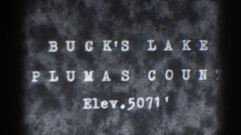8mm title card for Bucks Lake, Plumas County, California, showing white type over a mottled dark background.