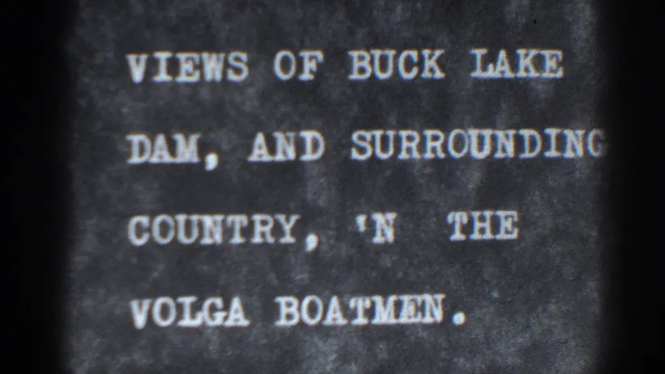 Home-movie intertitle identifies views of Buck Lake, the dam, and surrounding country, with visible type and film wear.
