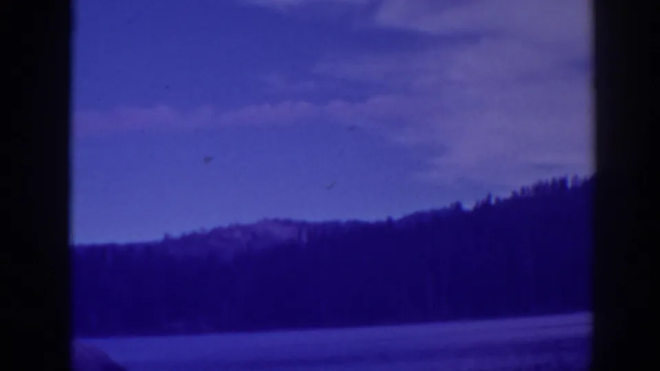 Wide 8mm view of Bucks Lake, California, with water, trees, distant hills, and a blue-toned sky.