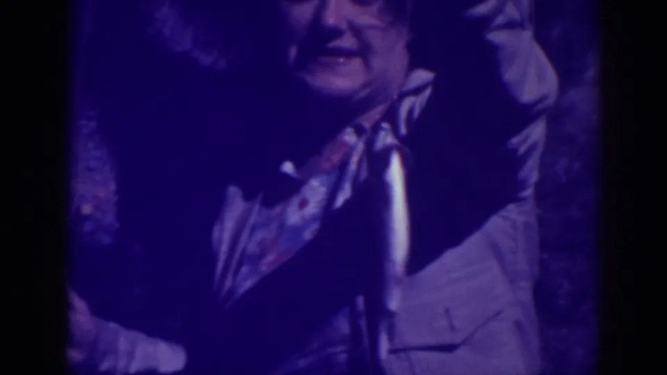 A person at Bucks Lake, California in 1938 holds a silvery fish toward the camera in grainy purple-tinted 8mm footage.