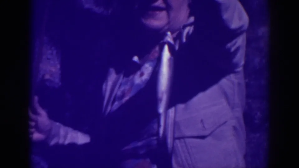 The home movie shows a person in a light jacket holding the fish close to the lens during the 1938 Bucks Lake fishing trip.
