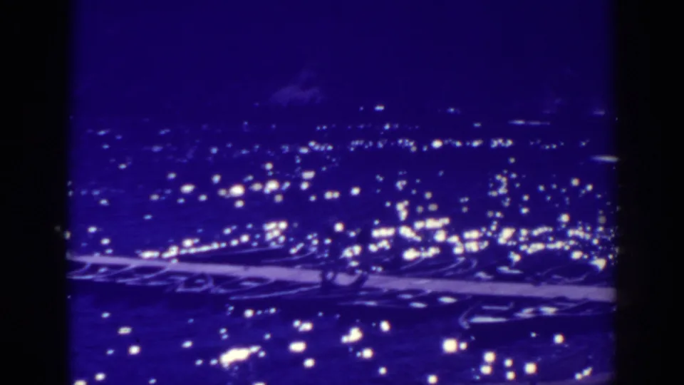 Bucks Lake at night in a purple-tinted 8mm frame, with bright lights scattered across the dark view.