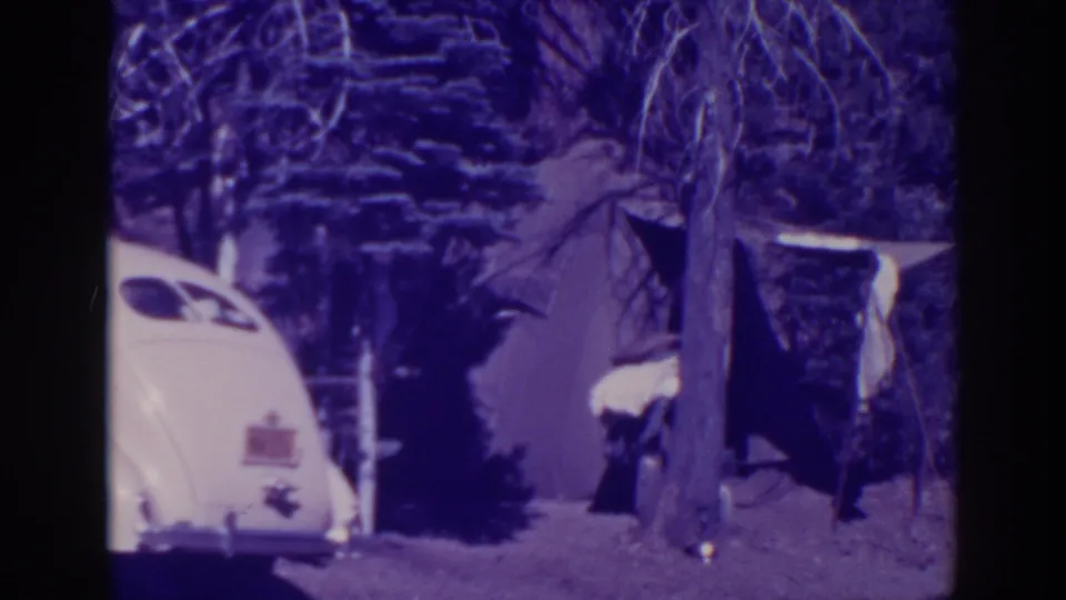 The final frame shows the white car, tent entrance, and trees at the 1938 Bucks Lake campsite after the woman has moved from clear view.