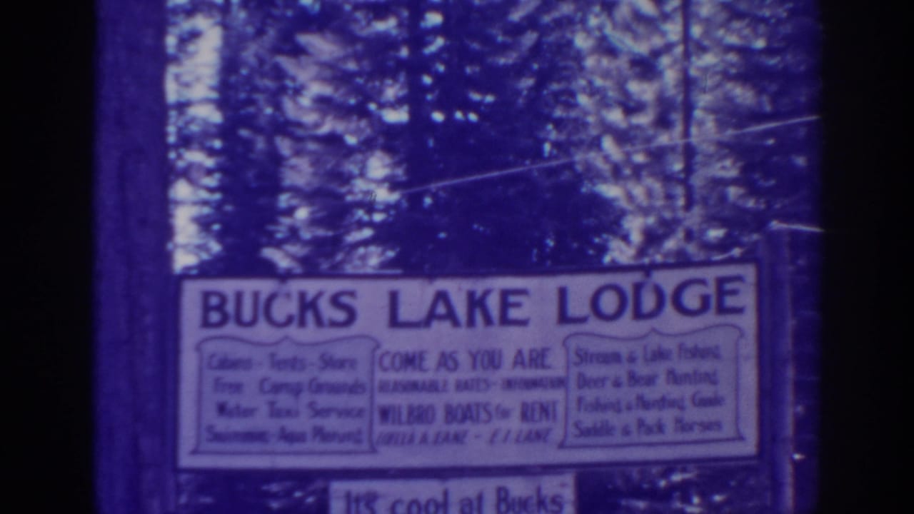 1938 Bucks Lake, California home-movie frame showing a white Bucks Lake Lodge sign among tall pine trees.