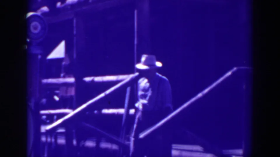 The Bucks Lake home movie shows the hatted man moving down the wooden steps outside the rustic building.