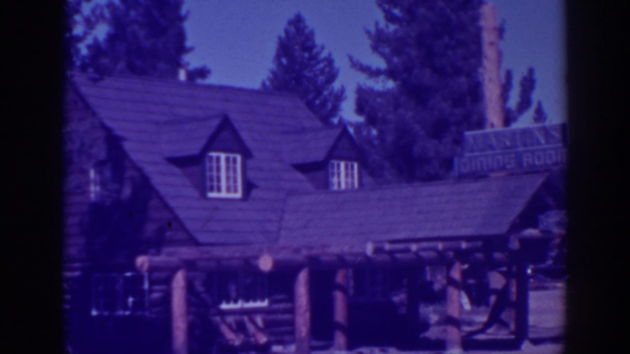 Rustic restaurant exterior in El Dorado City, California, showing log walls, steep roofline, dormer windows, porch posts, and a dining room sign.