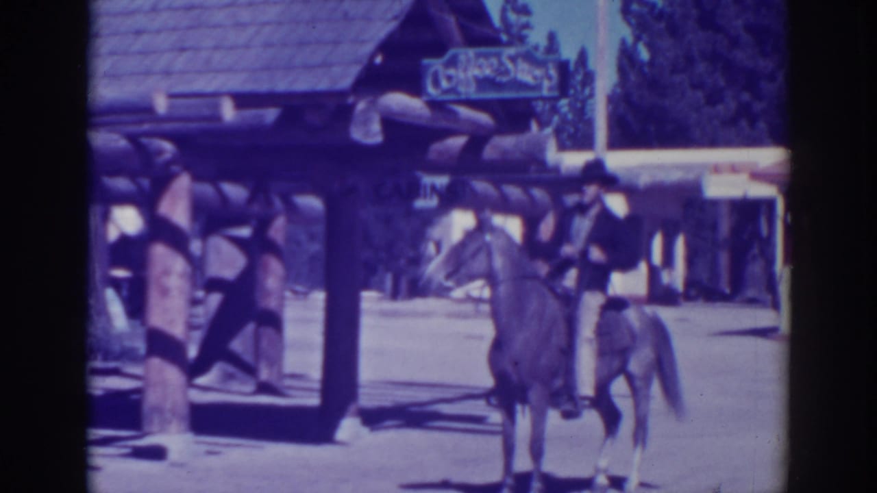 A rider on horseback appears in a sunlit El Dorado City street, with a rustic building and Coffee Shop sign behind him.