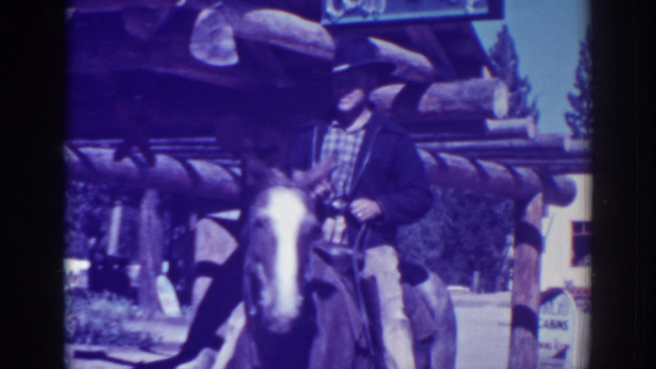 The rider and horse move in front of a rustic El Dorado City building, with log beams and partial signage visible above.