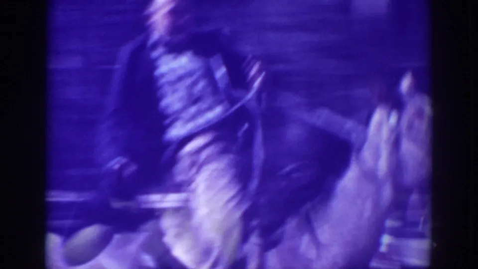 A close, motion-blurred view shows the mounted rider passing near the camera on the wooded dirt road in El Dorado City.