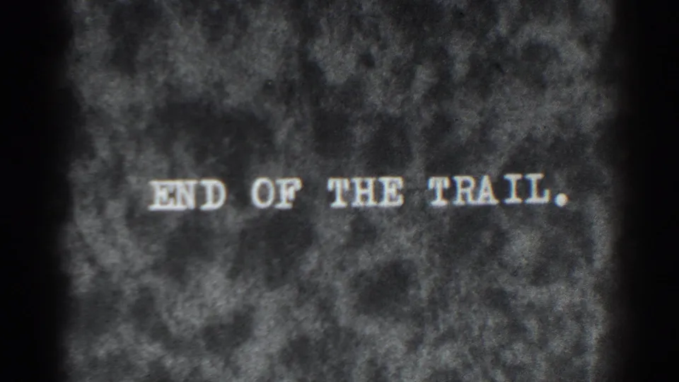 1938 8mm home-movie end title card reading 'END OF THE TRAIL' on a mottled dark background.