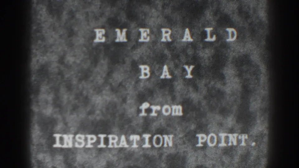 1938 8mm title card identifies Emerald Bay from Inspiration Point, with soft focus, grain, and dark film borders.
