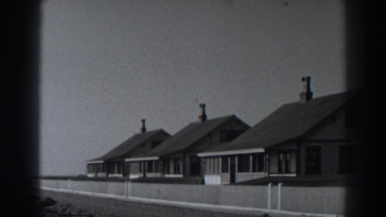 Seaside cottages with porches and chimneys viewed from outside.