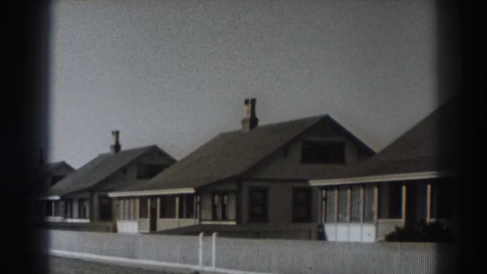 Final frame of the Fort Ross cottage row, with low fencing, chimneys, porch fronts, and heavy 8mm frame edges.
