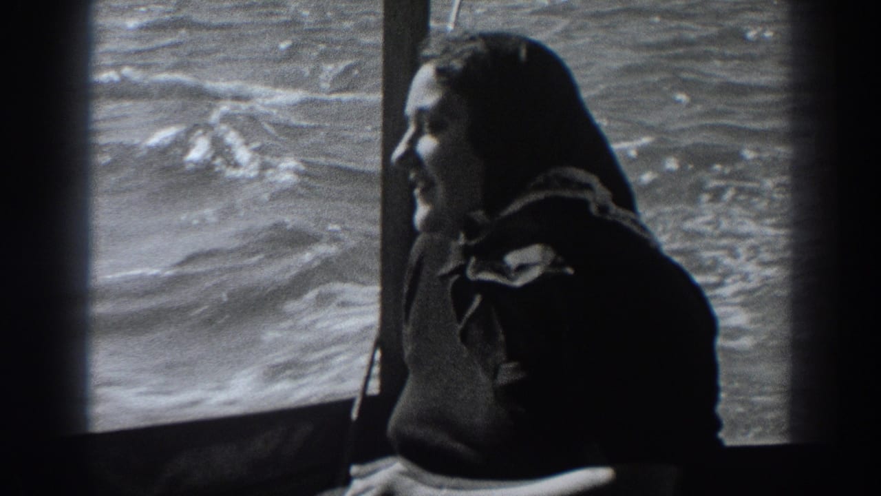 Woman in profile smiles inside a boat, framed against bright moving water outside.