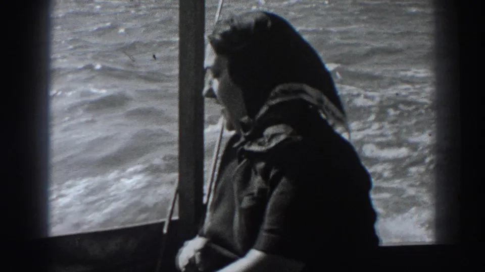 The Fort Ross boat scene ends with the woman looking sideways in the cabin, framed by window posts and moving water outside.