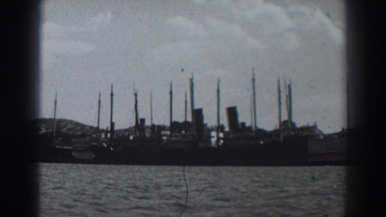 Harbor silhouettes with ships, masts, water, and a cloudy sky.
