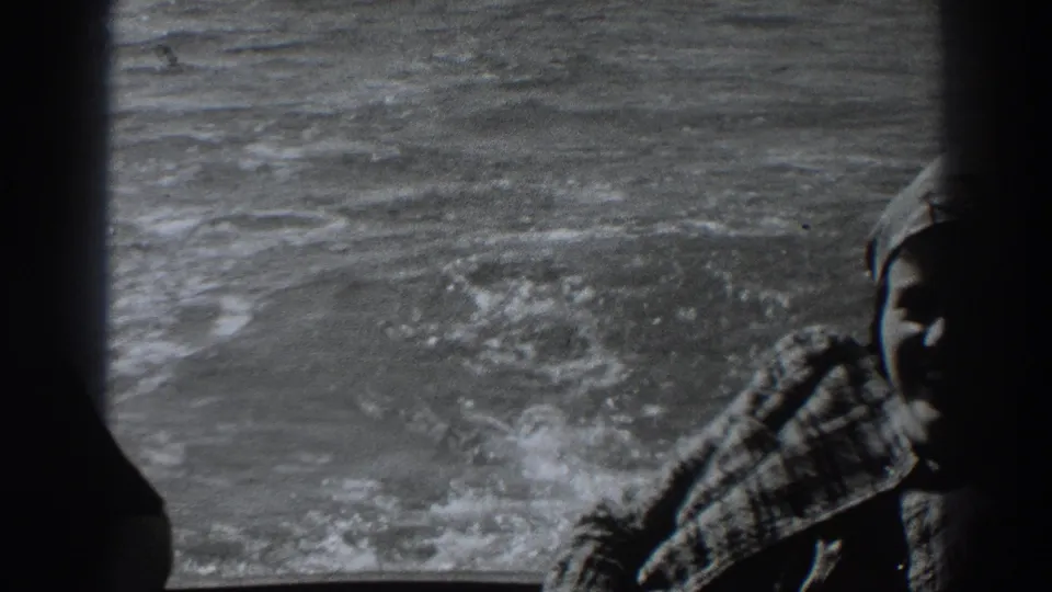 The woman appears near the edge of the frame as the boat moves through rough water near Fort Ross, California, in 1938 footage.