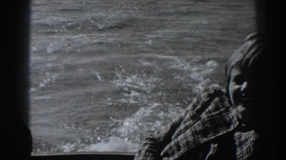 A darker 1938 frame shows the seated woman under the boat window, with textured water and wake visible beyond the glass.